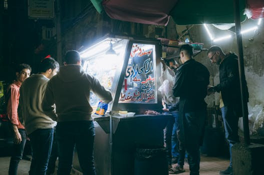 night-market, street-food, people, food-stall, urban-scene, arabic-script